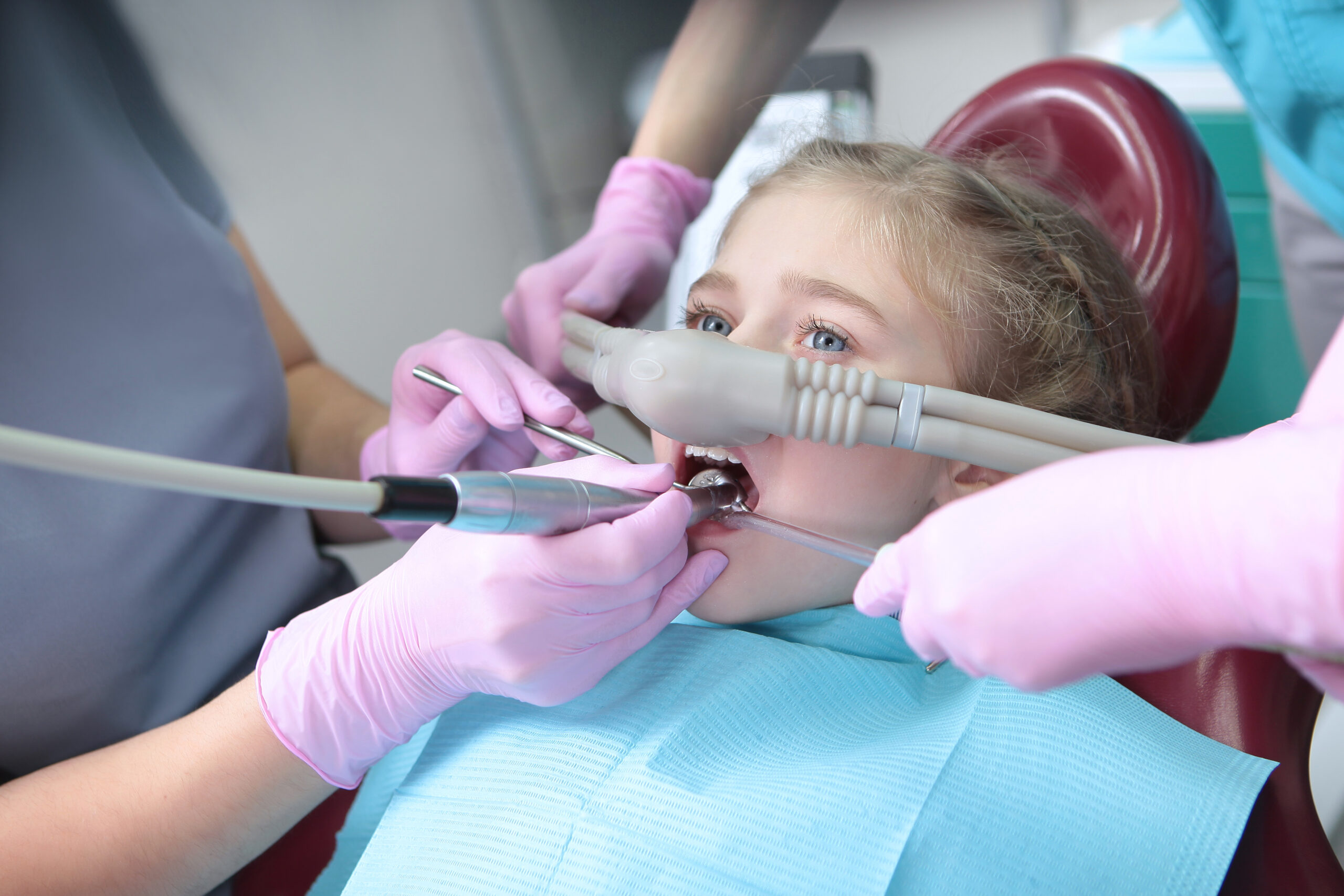 Dental treatment in a child with the use of nitrous oxide. Relaxation of the patient before surgical or dental procedures. Children's modern dentistry. The concept of healthcare. Horizontal orientation of the photo.