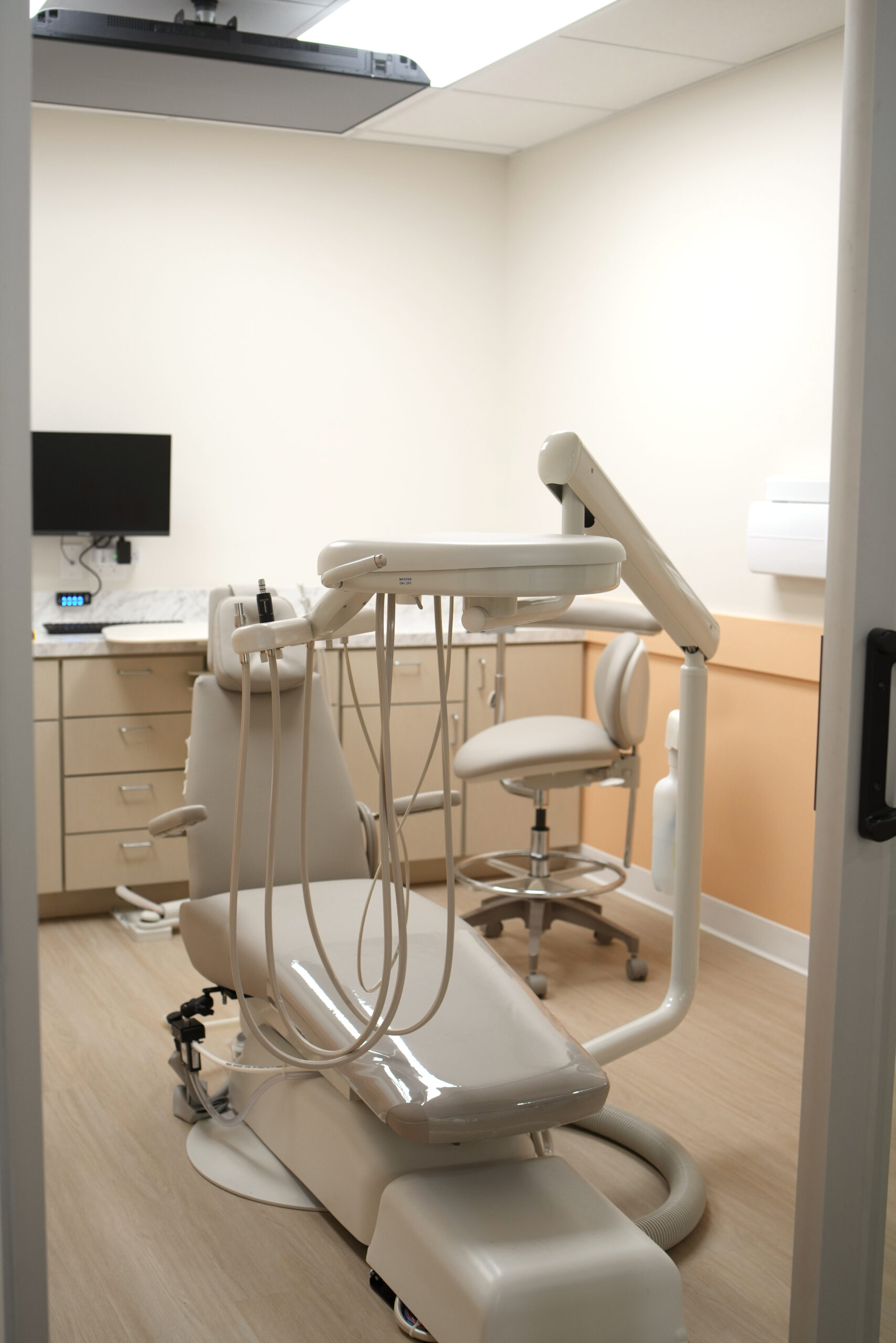 Modern pediatric dental exam chair in a bright treatment room