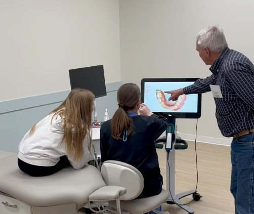 Dr. Wengler and parent reviewing teen's 3D Invisalign scan on monitor