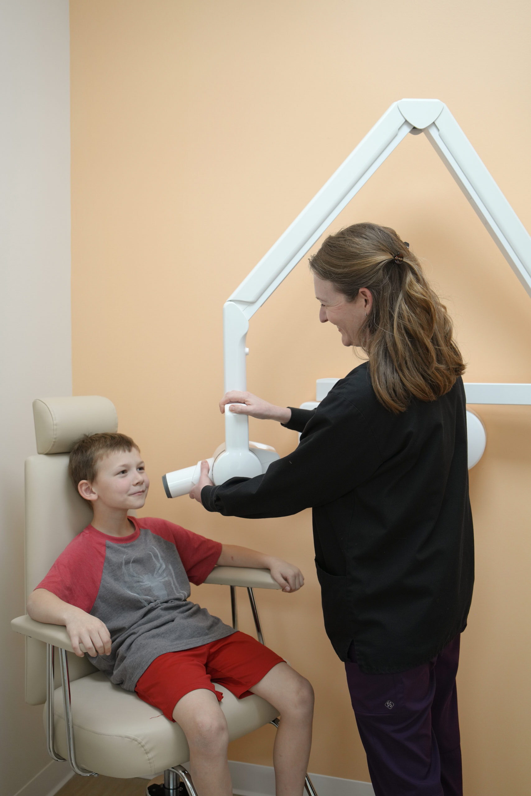 Young patient positioned for a safe digital dental X-ray