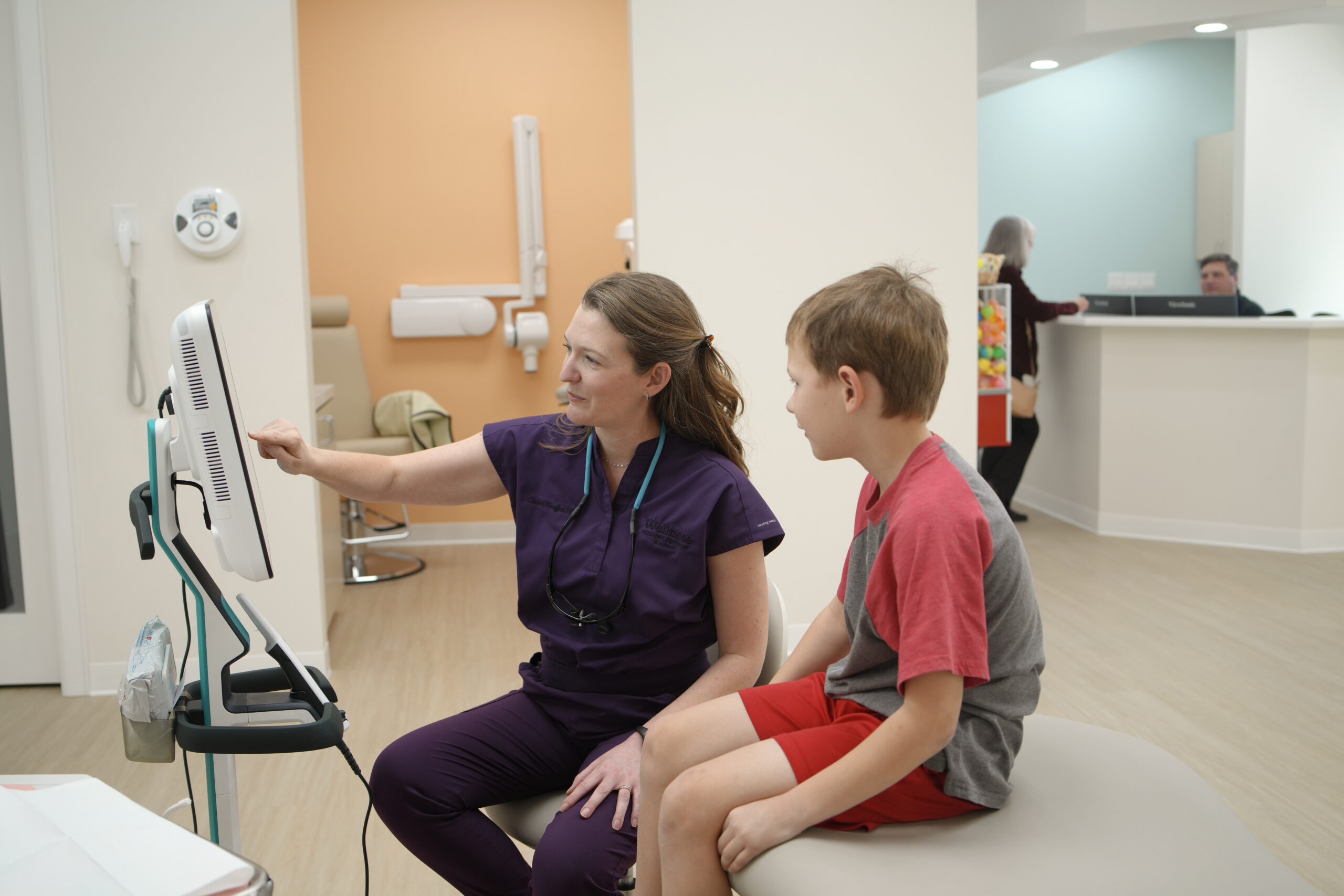 Dr. Wengler explaining dental X-ray results to a young patient