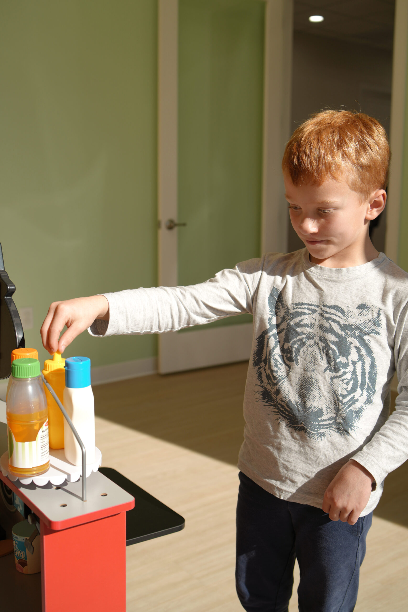 Child exploring interactive activities in the waiting room