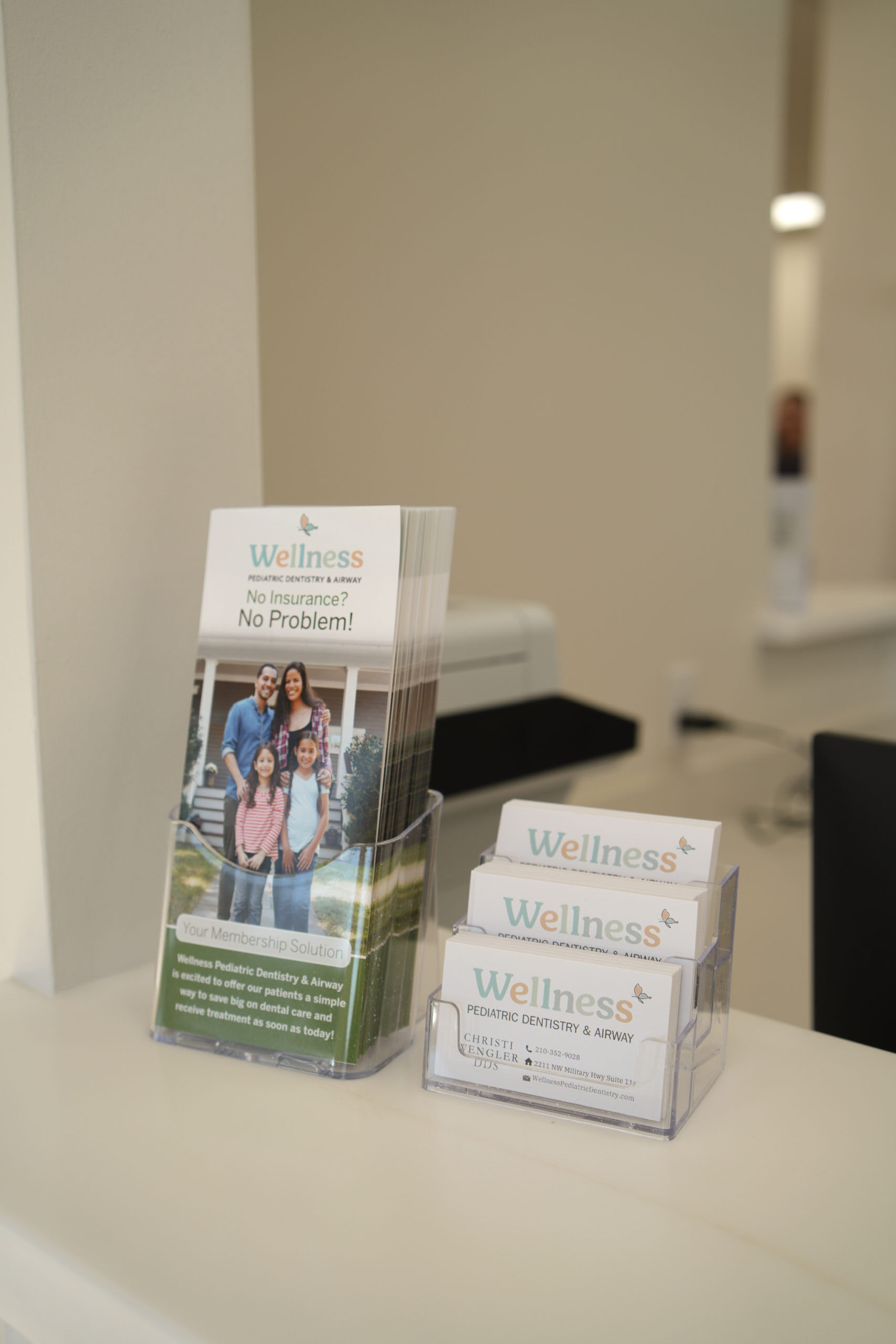Business cards and information materials displayed at reception desk