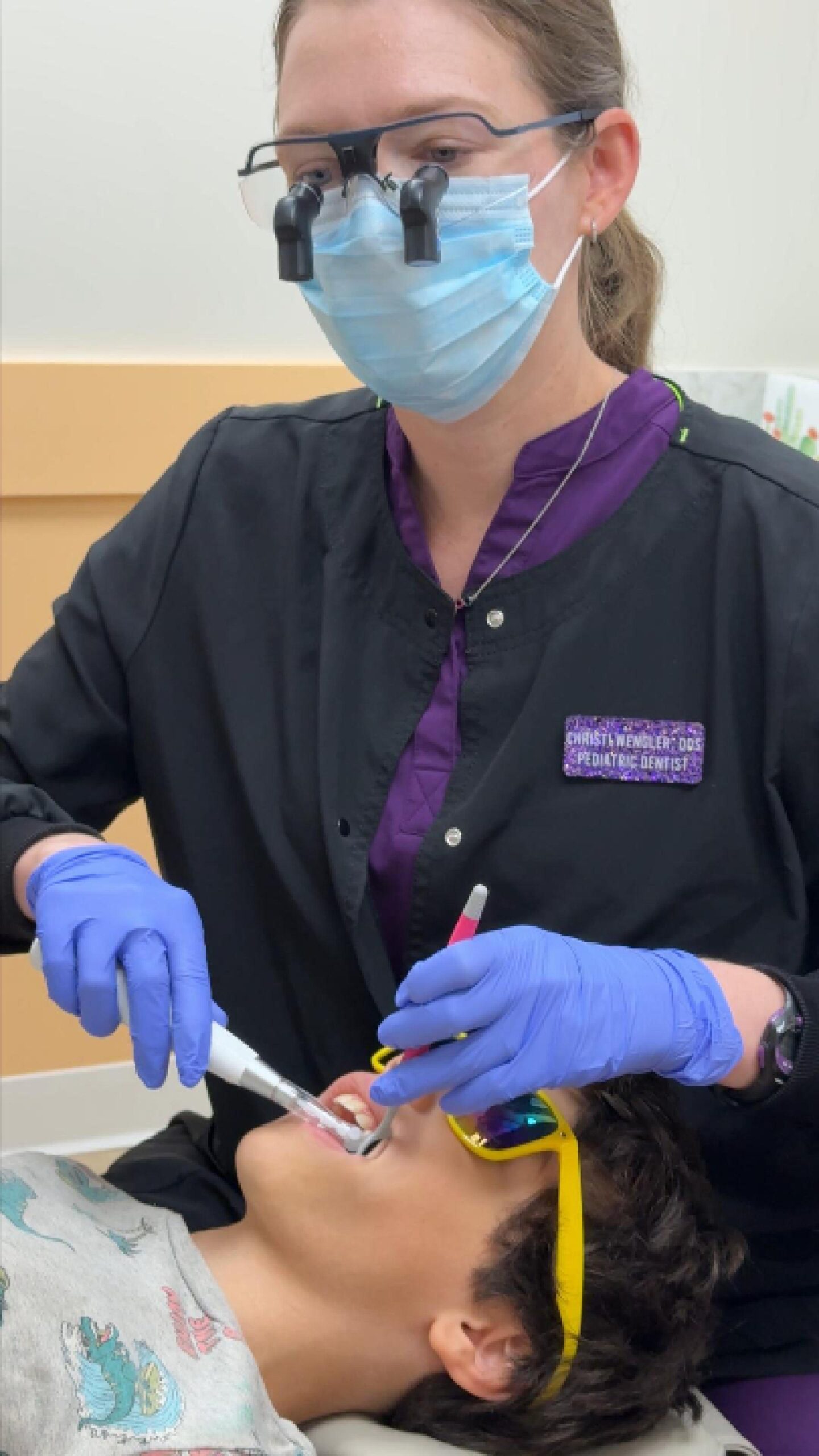 Dental hygienist treating young patient