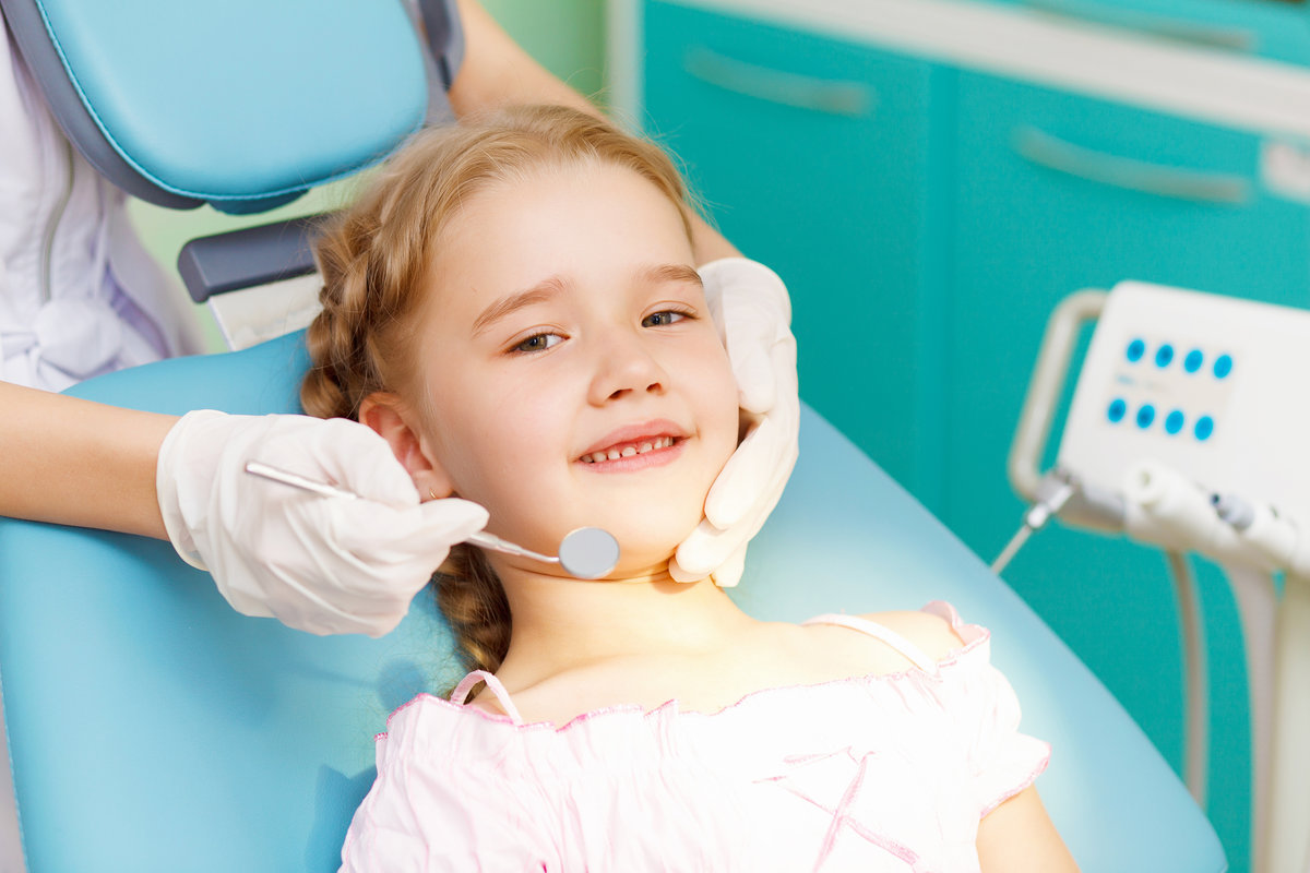 Child smiling in dental chair
